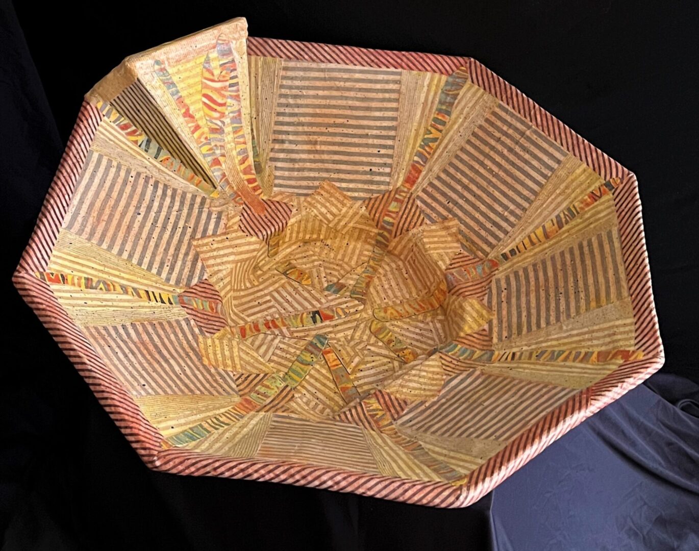 Striped fabric strips are collaged inside and outside of this handcrafted bowl.